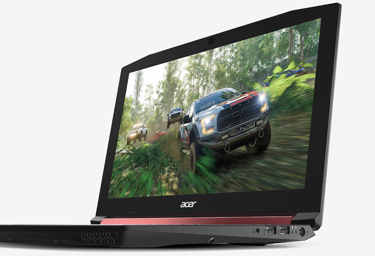 Acer NITRO 5 open, a facing to the left with pickup trucks racing through a forest