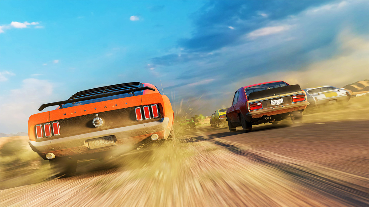 Different years of Ford Mustangs racing away through a dirt road during the day