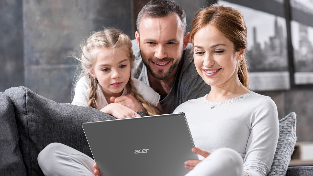 A family is all around a laptop