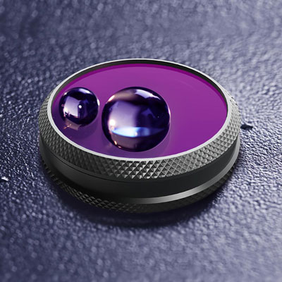   A filter on display with lens facing up, with two drops of water on the lens glass. The water drops are in round shape 
