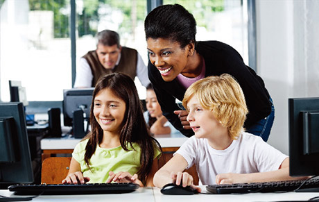 Child Student and Adult Teachers in a Computer Lab