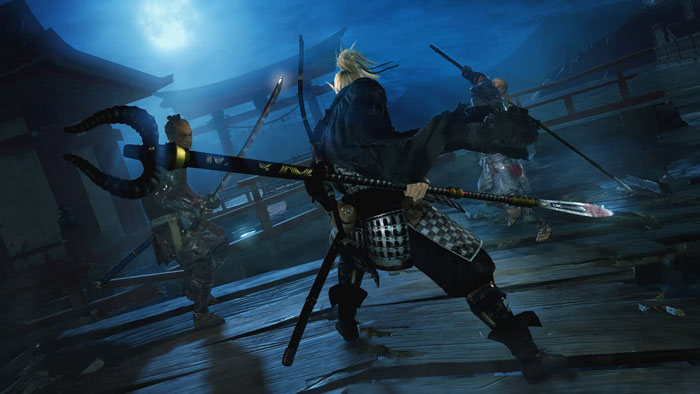 a male character fighting with two enemies in the moonlight