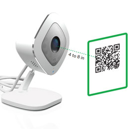  An Arlo Q with a QR code in front of the camera lens  