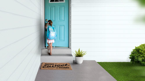 a girl opening the door of her home