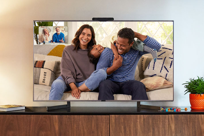 Portal TV moutned on a TV making video calls between one family and their grandparents