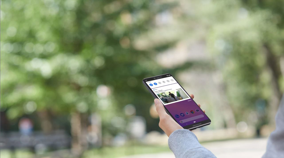 A phone is displaying a delivery man with a package under his arm arpproaching your house.