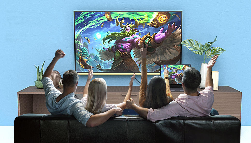 two couples sitting on the couch are wathcing a show on a large TV