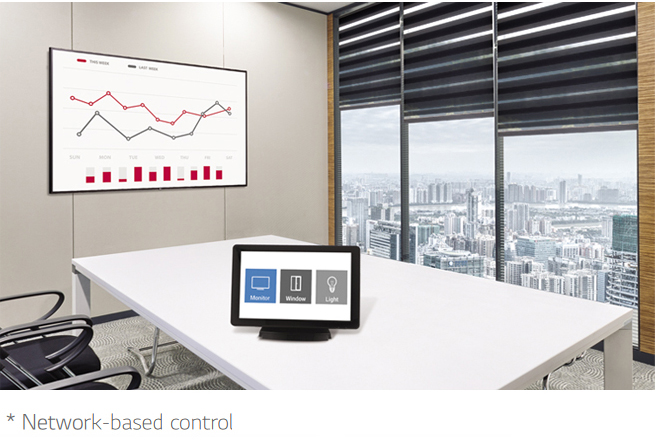 Mounted LG display in an office meeting room with a control tablet on the white desk