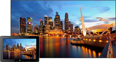 Tablet in Front of the Avera TV, Casting an Image of a boat by a city skyline at dusk