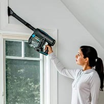 A Woman Using the Shark IF200W in Above-Floor Cleaning Mode