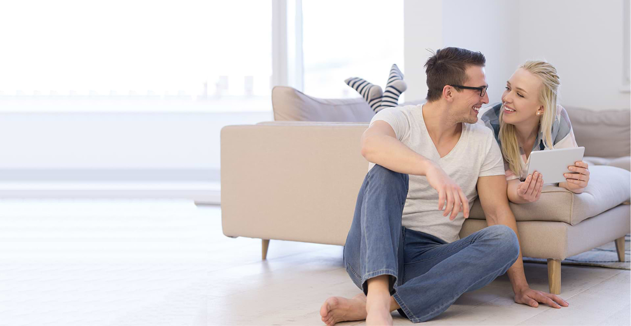 A man and a woman are looking at each other with smiles on their faces.