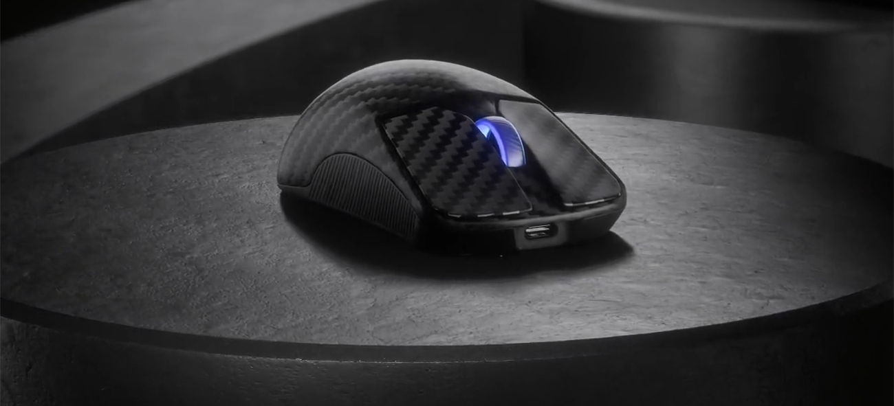ROG Harpe Ace Extreme carbon fiber gaming mouse on a dark stage with ROG Harpe Ace Extreme neon outline text