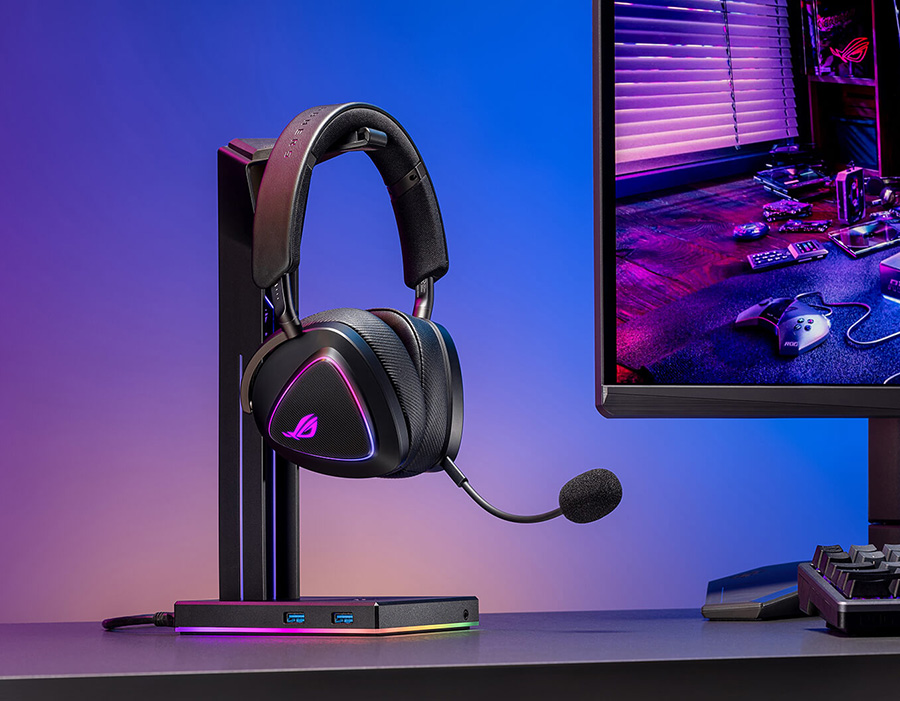 ROG Delta II on a headset stand beside ROG monitor and keyboard