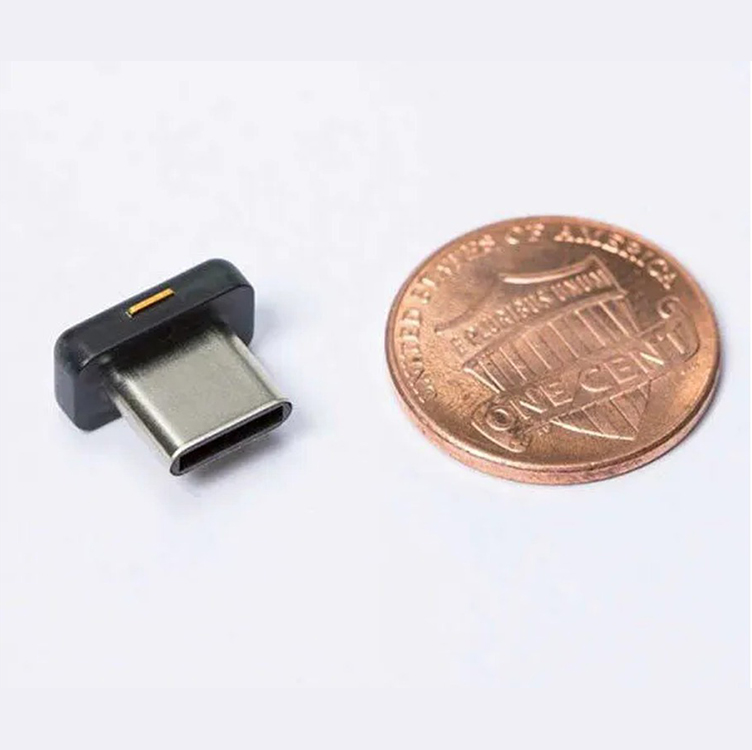 YubiKey 5C Nano FIPS next to a coin for size comparison