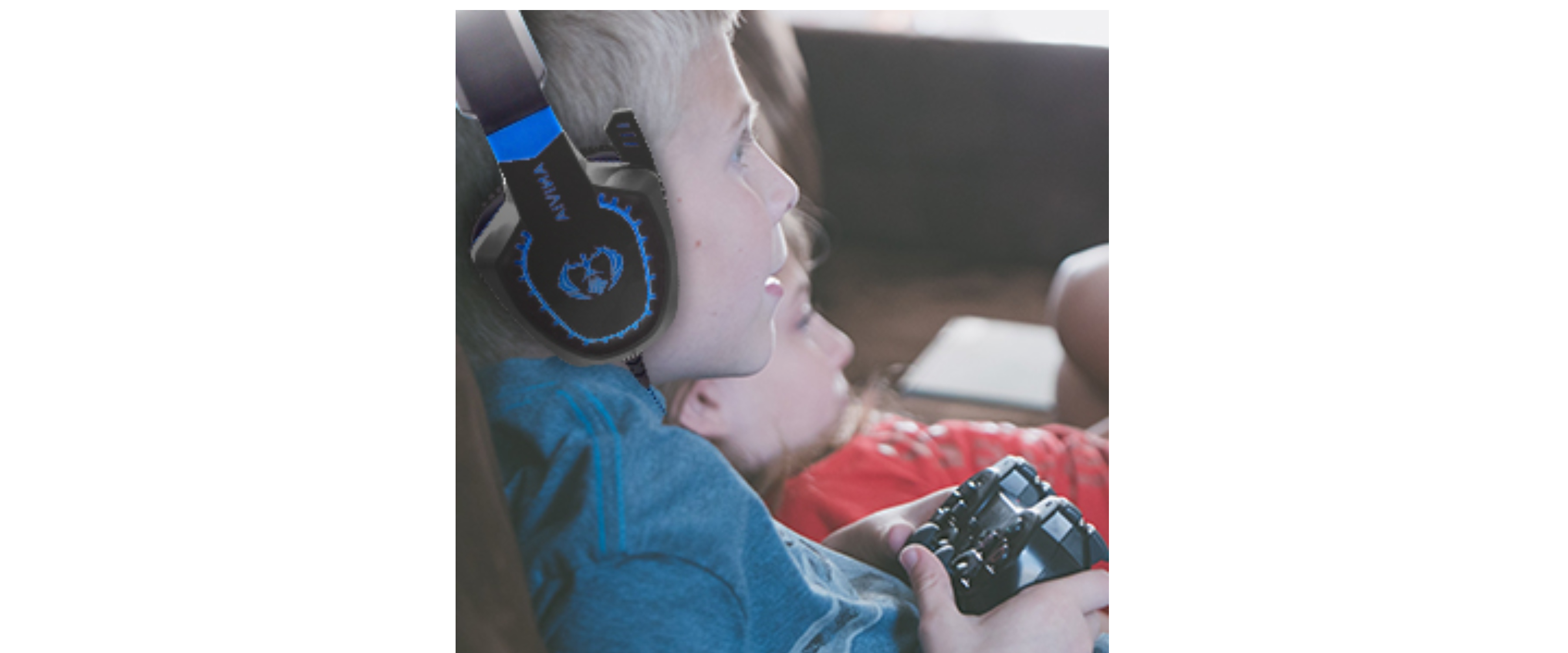 Kids wearing gaming headset, game controller, home gaming scene
