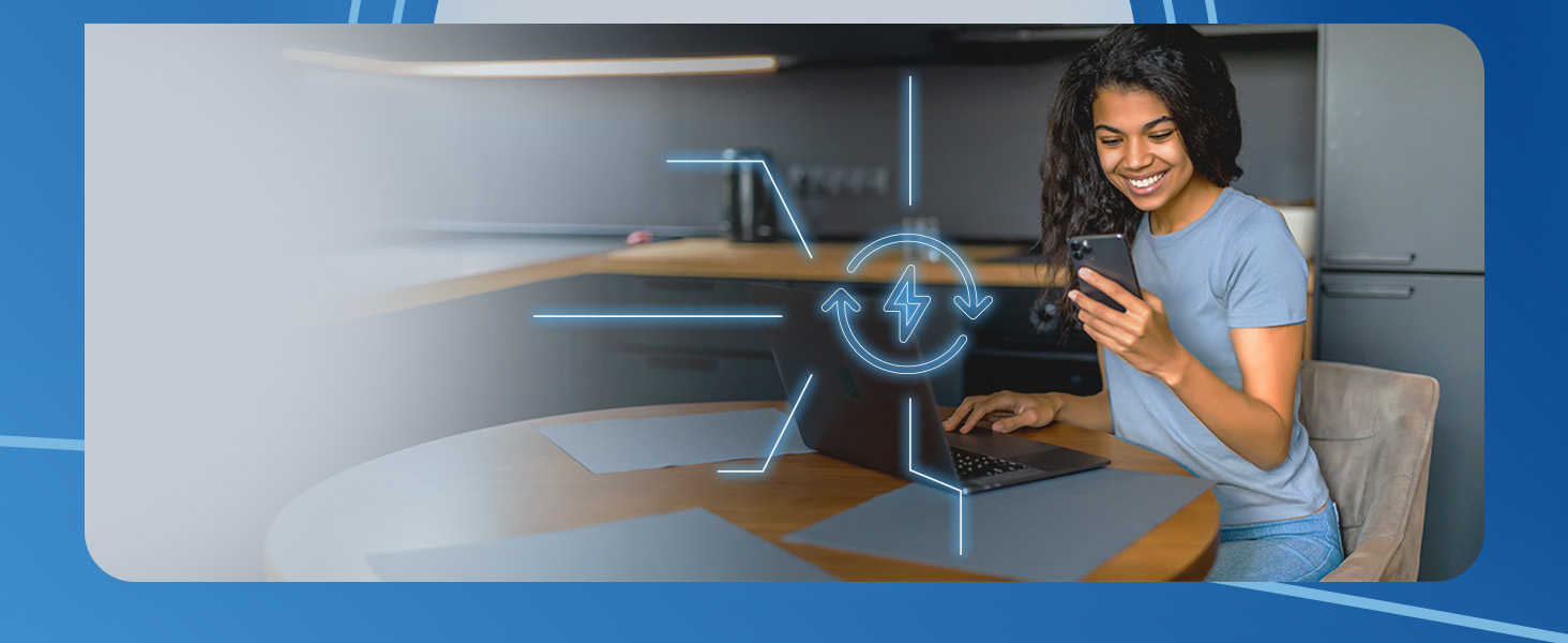 Woman staring at her phone while working at home on her laptop