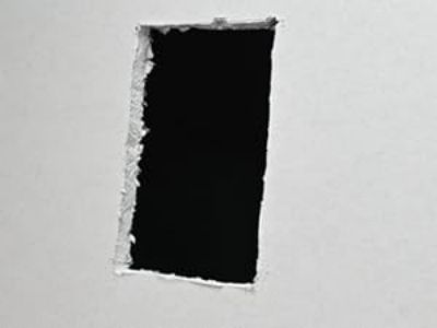 Cut a hole in the drywall.