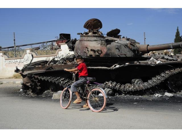 A Syrian Boy On His Bicycle In Front Of A Destroyed T 72 Battle Tank Poster Print 34 X 22 Newegg Com