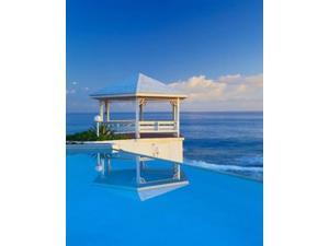 Gazebo reflecting on pool with sea in background, Long Island, Bahamas Print by Kent Foster (16 x 20)