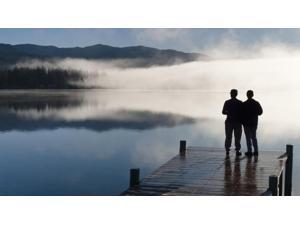 Couple Standing On A Dock And Silhouetted Against The Fog Lifting From Lake Whatcom During Winter, Bellingham Washington