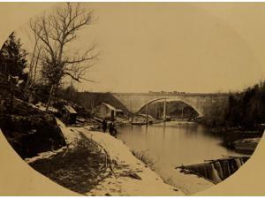 Two men standing near the Washington Aqueduct with the Cabin John Bridge in the background Poster Print (18 x 24) Two men standing near the Washington Aqueduct with the Cabin John Bridge in the background Poster Print (18 x 24)