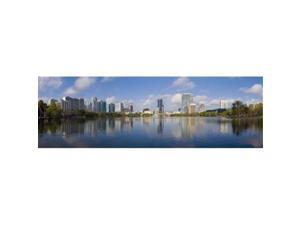 Panoramic Images PPI130648L Reflection of buildings in a lake  Lake Eola  Orlando  Orange County  Florida  USA 2010 Poster Print by Panoramic Images - 36 x 12