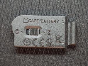 Nikon Genuine Battery Door Cover Lip For Nikon 1 J1 Camera Body Nikon Genuine Battery Door Cover Lip For Nikon 1 J1 Camera Body