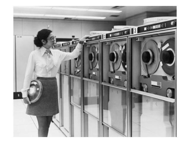 Businesswoman working with computer tape drives, 1970 Poster Print (24 x 36)