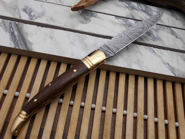 Laguiolle Folding Damascus steel knife. hand forged custom twist pattern 4' Blade. Available in various scales with brass bolster. Cow hide leather...