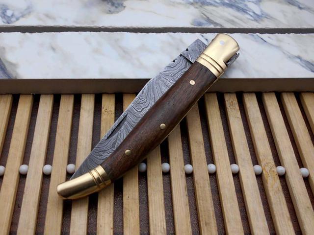 Laguiolle Folding Damascus steel knife. hand forged custom twist pattern 4' Blade. Available in various scales with brass bolster. Cow hide leather...