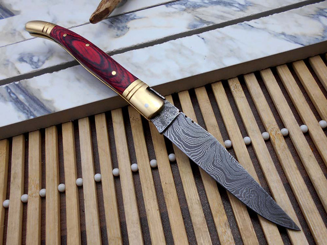 Laguiole Folding Damascus steel knife. hand forged custom twist pattern 4' Blade. Available in various scales with brass bolster. Cow hide leather...