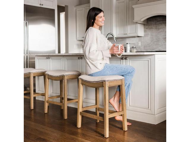 Maven Lane Adrien 26 Inch Counter Height Upholstered Backless Saddle Barstool in Natural Wood Finish with Wheat Cream Fabric Cushion Seat