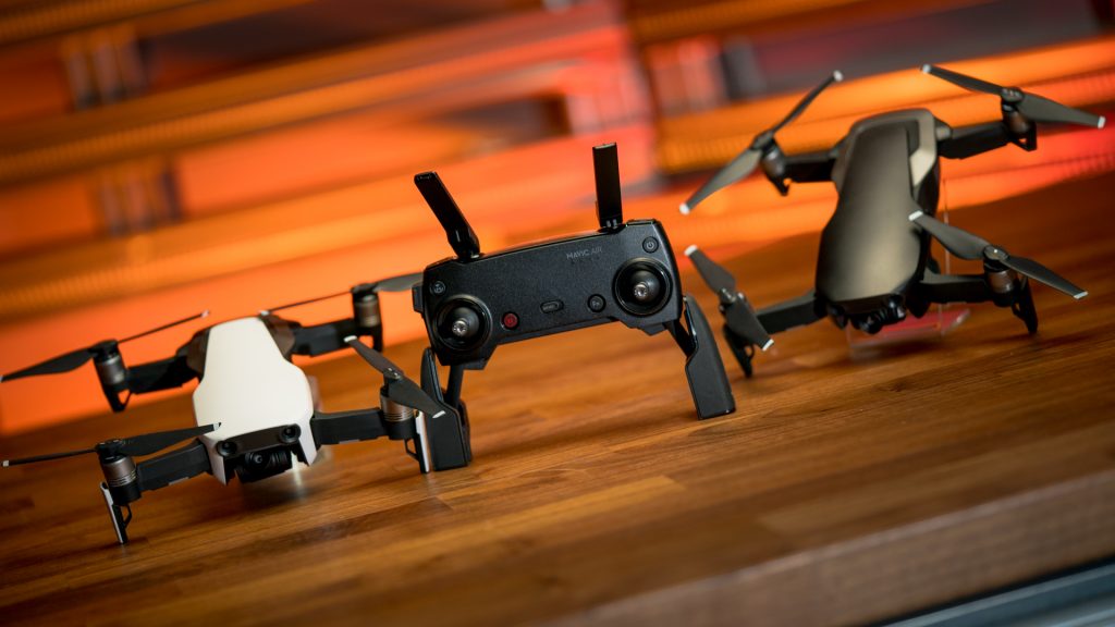 DJI Mavic Air, drones, photography. The new DJI Mavic Air drones in Arctic White and Onyx Black sit with the collapsible remote, now potentially the most portable and capable photography drone. 