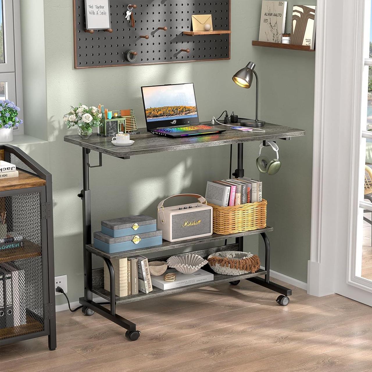 Alt view image 2 of 7 - 32" Height Adjustable Standing Desk with Power Outlets - Manual Rolling Stand Up Desk with Wheels Small Portable Computer Desk Mobile Laptop Table with Storage Shelves for Home Office, Grey Oak