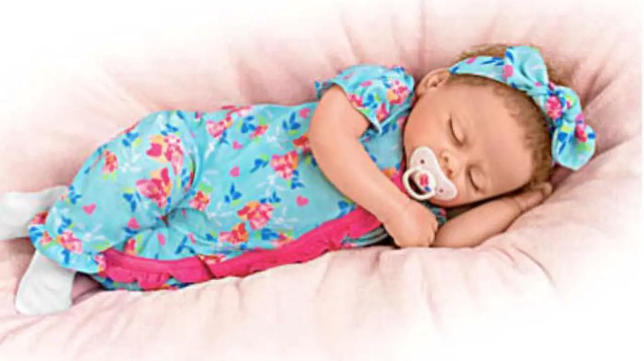 Alt view image 7 of 7 - The Ashton - Drake Galleries Bella Authentic Silicone Baby Doll "Breathes" And "Coos" with Custom Floral Sleeper & Headband TrueTouch® Authentic Silicone Sleeping Doll by Linda Murray 19-inches