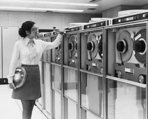 Businesswoman working with computer tape drives, 1970 Poster Print (24 x 36) Businesswoman working with computer tape drives, 1970 Poster Print (24 x 36)