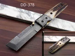Damascus steel Tanto blade Folding Knife, Available in Natural Ram, Bull horn, Camel Bone, Stag Antler scales with Damascus bolster, Cow hide leather sheath, equipped with Thumb knob & liner lock