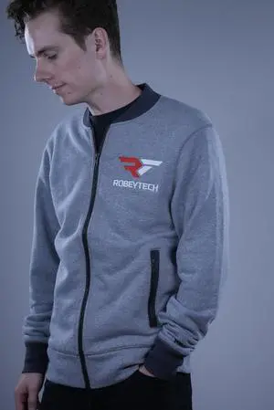 The Premier Robeytech Logo on a New Era French Terry Baseball Full-Zip jacket in Light Graphite Twist. The perfect combination for our first jacket.