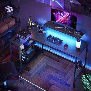 Bestier 48" L-Shaped Gaming Desk with LED Lights, Power Outlets, and Monitor Stand Carbon Fiber Black