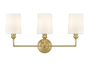 Leena Collection | 99803-VB | Indoor 3 Light Vanity in Vintage Brass with White Fabric Shade | Elegant and Versatile Design for Any Bathroom Leena Collection | 99803-VB | Indoor 3 Light Vanity in Vintage Brass with White Fabric Shade | Elegant and Versatile Design for Any Bathroom