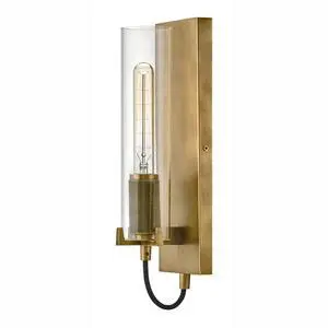 Ryden Medium Indoor Single Light Wall Sconce, Heritage Brass Finish | Clear Glass Cylinder Shade, Modern Industrial, Sleek, Includes Med. LED Bulb, Shown w/ T-Style Bulb, Hidden Mounting Hardware Ryden Medium Indoor Single Light Wall Sconce, Heritage Brass Finish | Clear Glass Cylinder Shade, Modern Industrial, Sleek, Includes Med. LED Bulb, Shown w/ T-Style Bulb, Hidden Mounting Hardware