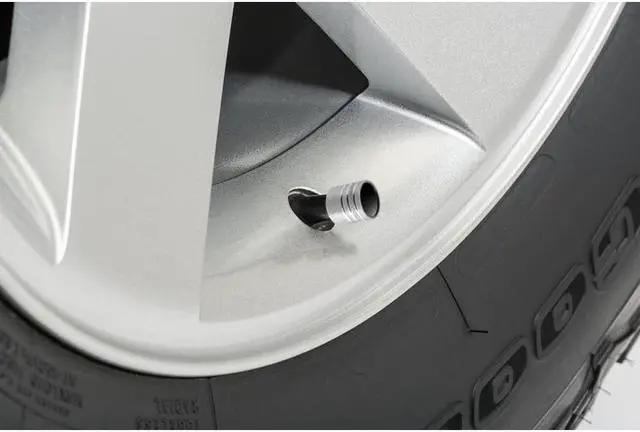 Alt view image 2 of 4 - Nissan Titan Black on Silver Aluminum Cylinder-Style Tire Valve Stem Caps