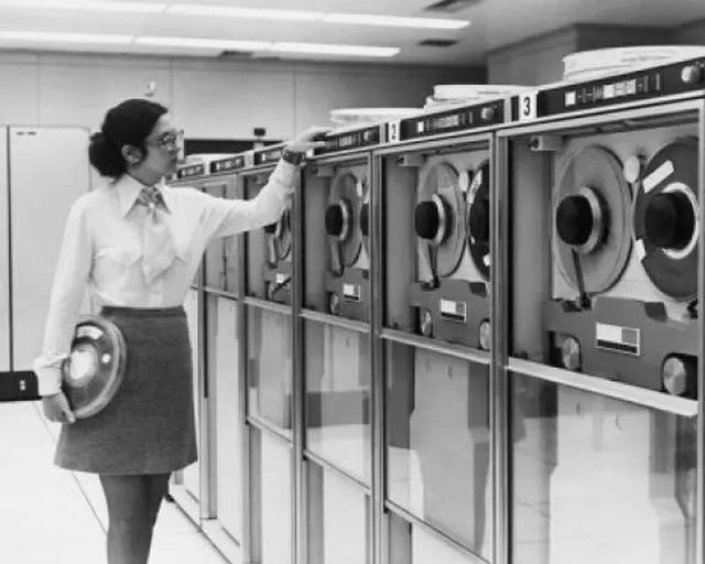 Main image of Businesswoman working with computer tape drives, 1970 Poster Print (24 x 36)