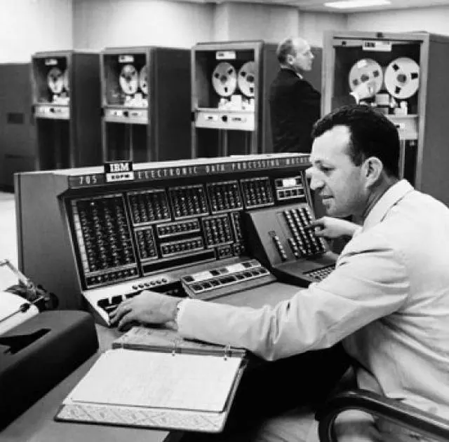 Main image of Side profile of a mid adult man operating a computer Poster Print (24 x 36)