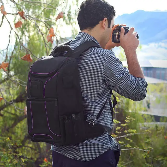 Alt view image 4 of 9 - Digital SLR Camera Backpack (Purple) with 15.6" Laptop Compartment by USA Gear features Padded Custom Dividers , Tripod Holder , Rain Cover and Storage for DSLR Cameras by Nikon , Canon , Sony