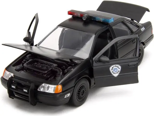Alt view image 2 of 11 - Ford Taurus OCP Matt Black "Detroit Police" and Robocop Figure "Robocop" (1987) Movie 1/24 Diecast Model Car by Jada