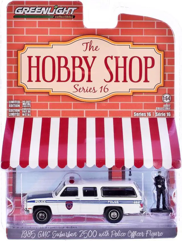 Alt view image 3 of 3 - 1985 GMC Suburban 2500 "NYC Transit Police Department" White with Blue Stripes and Figure 1/64 Diecast Model Car by Greenlight