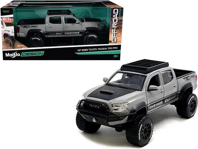 Main image of 2023 Toyota Tacoma TRD PRO Off Road Truck Cement Gray with Black Hood and Roofrack 1/27 Diecast Model Car by Maisto