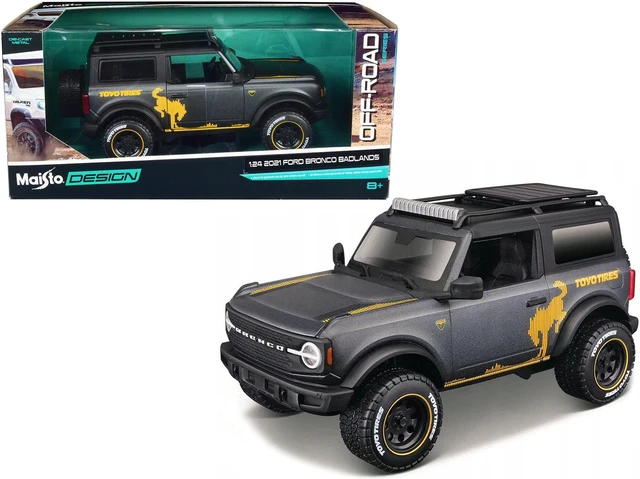 Main image of 2021 Ford Bronco Badlands Dark Gray Metallic with Gold Graphics and Roof Rack "Off-Road" 1/24 Diecast Model Car by Maisto