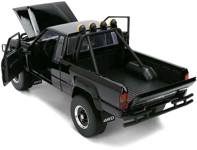 Alt view image 5 of 7 - 1985 Toyota SR5 Pickup Truck Black with Marty's Skateboard "Back to the Future" (1985) Movie 1/24 Diecast Model Car by Jada